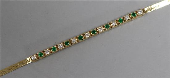 A 14ct gold, emerald and diamond small line bracelet, 15cm.